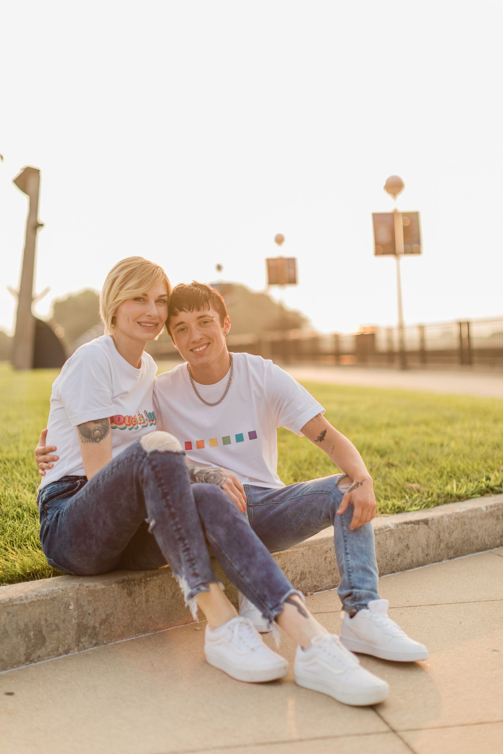 Couple sporting LGBTQ+ clothing during sunset