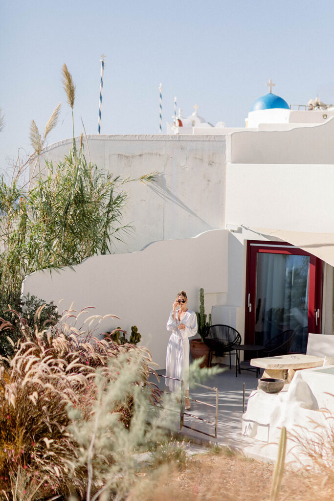 bride getting ready on wedding day in Santorini - Best destination wedding cities