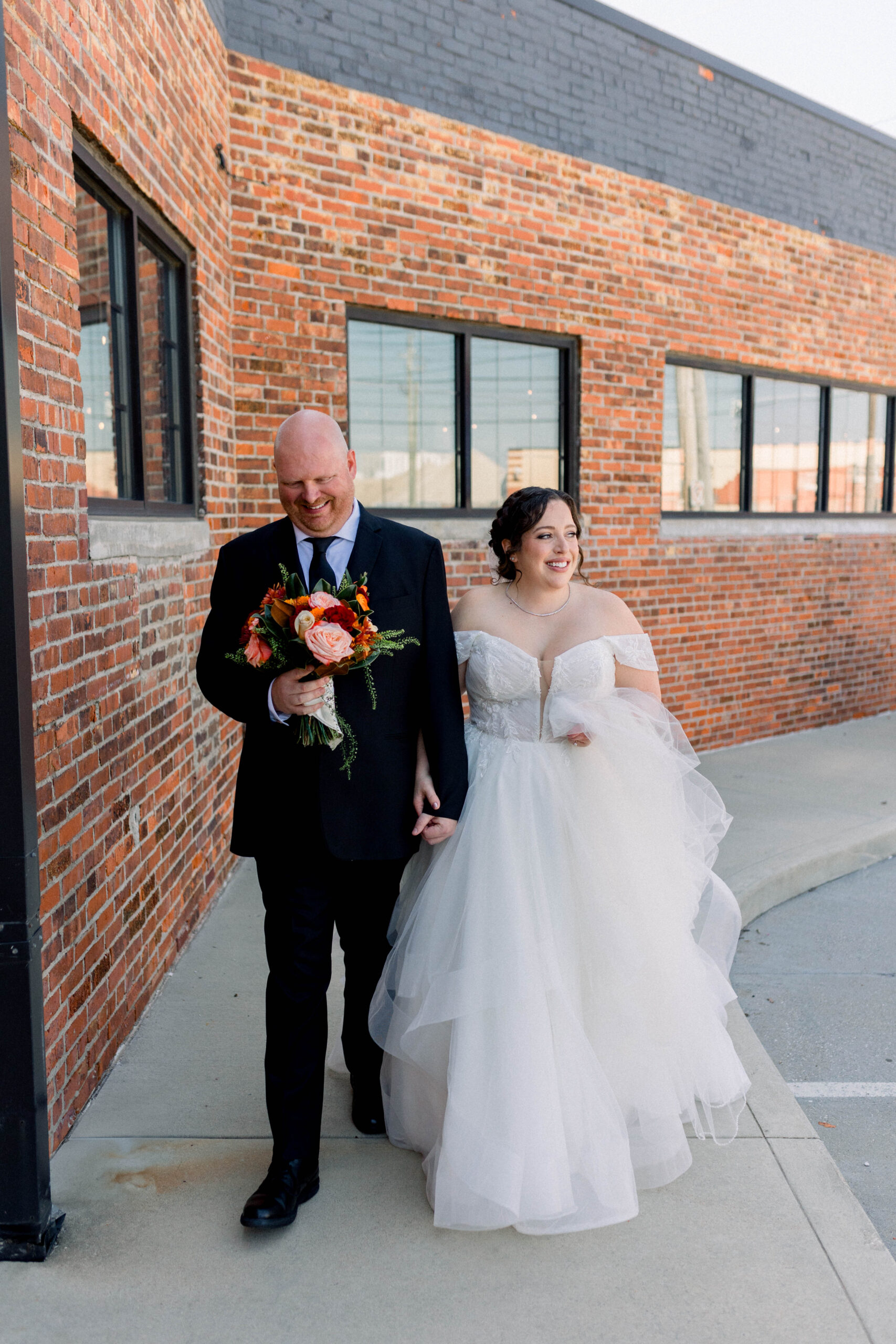 bride and groom walking in to their reception.